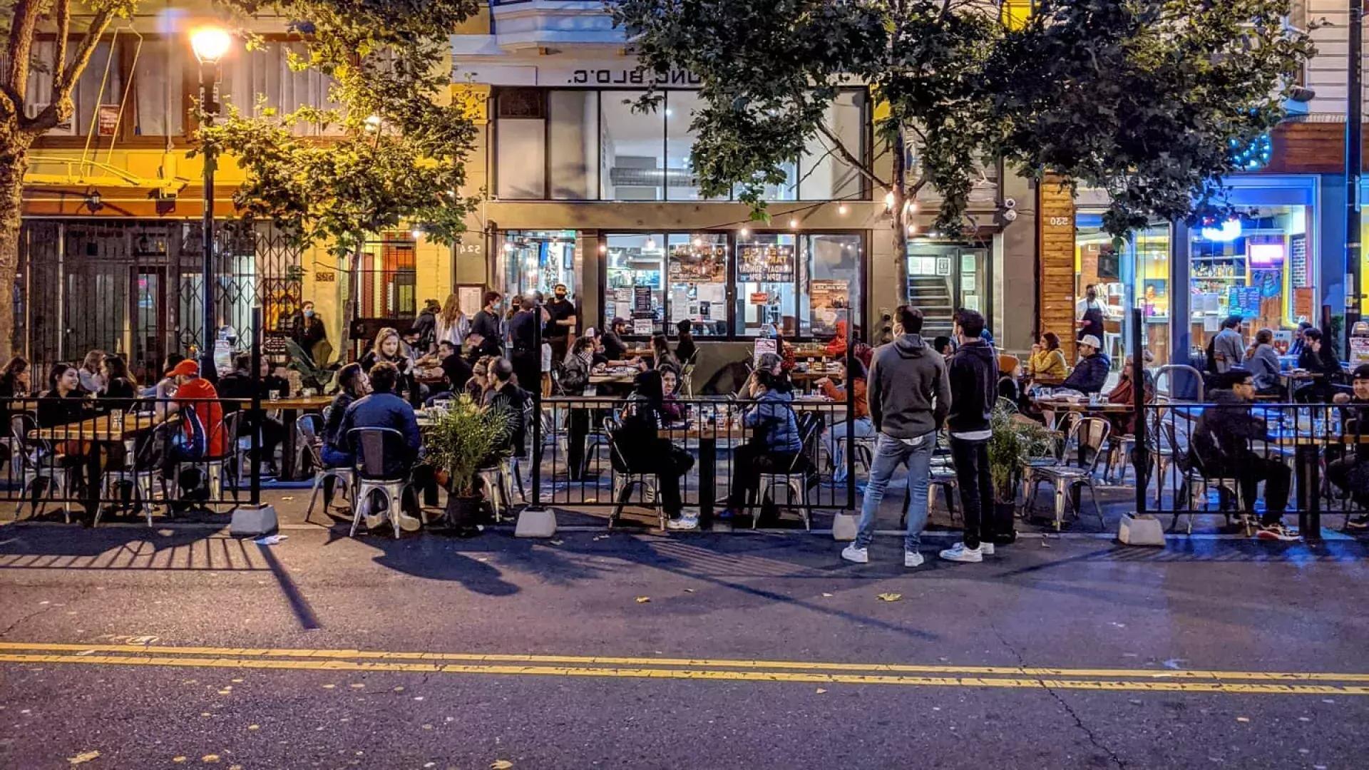 A crowd enjoys food and drink along San Francisco's Valencia Street